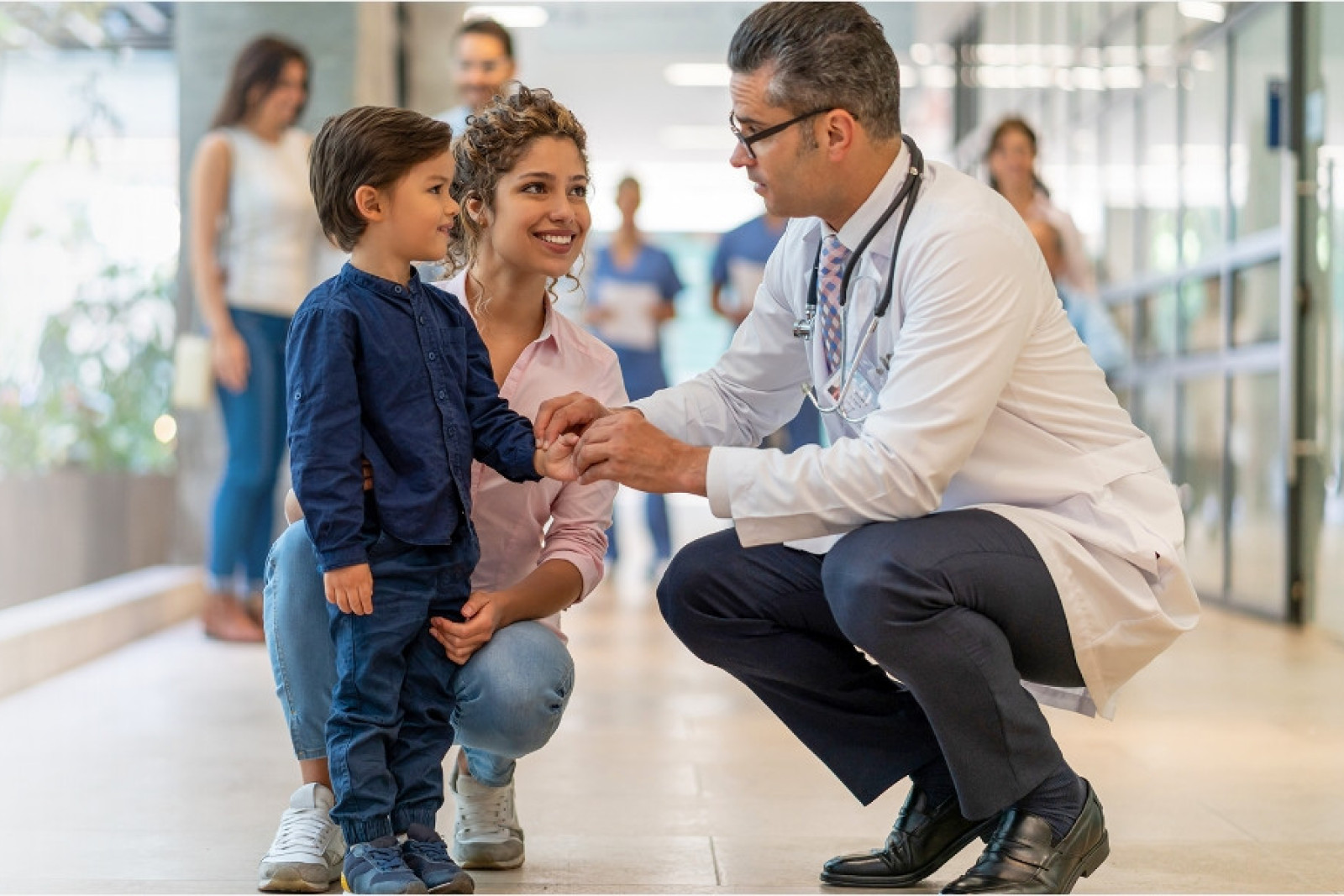 male doctor greeting a child